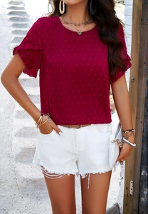 Detail of red short sleeve top with jacquard texture and elegant ruffle cuffs design