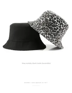 Detalle de sombrero de pescador reversible con estampado de leopardo gris y lona negra
