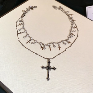 Close-up of double-layered gothic necklace with rhinestones and black stone cross charms