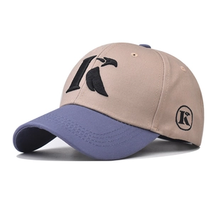Detailed macro view of the K letter embroidery on the khaki and blue cotton baseball cap