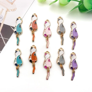 Detailed view of colorful enamel cat charms with articulated tails and gold metal borders