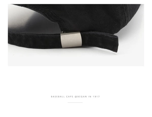 Detail of adjustable metal buckle on black washed cotton baseball cap for outdoor use