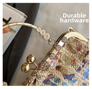 Close-up of golden metal frame with rhinestone flowers on a colorful straw clutch bag