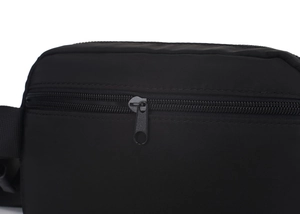 Close-up of matte black metal zipper on waterproof nylon crossbody bag with wide strap