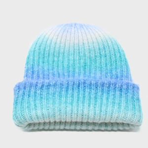 Detailed close-up of gradient blue knit beanie texture with soft mohair yarn material