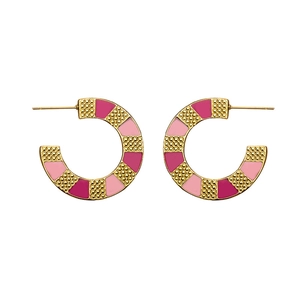 Macro detail of gold-plated C-shape earrings with pink and rose red enamel texture