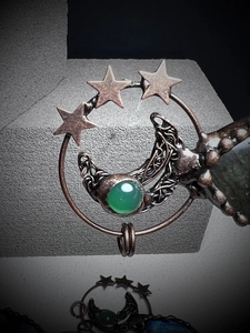 Handmade bronze star and crescent moon pendant featuring a green chalcedony gemstone