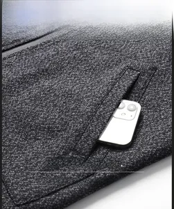 Detailed view of deep grey wool jacket pocket with smartphone storage capacity