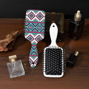 Bohemian style air cushion hair combs with colorful patterns on a wooden surface
