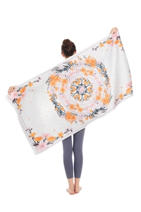 Detail of microfiber beach towel featuring a colorful mandala floral print on cream fabric