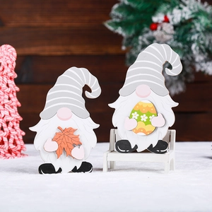 Wooden holiday gnomes set with maple leaf and egg patterns for festive home decor