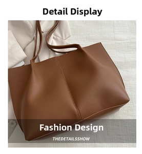 Detailed top view of a large brown leather tote bag with vertical stitching on white fabric
