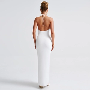 Detail of elegant white halter neck maxi dress featuring a deep open back and floor-length hem