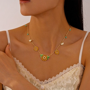Close-up of sunflower and bee necklace with blue beads worn on model for detail