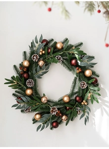 Detail of premium Christmas wreath with pine needles, gold ornaments and natural cones