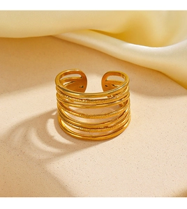 Detail of a vintage layered gold-plated wide ring with a unique hammered texture finish