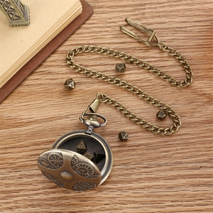 Steampunk bronze pocket watch with gear relief on wood desk with DND dice set