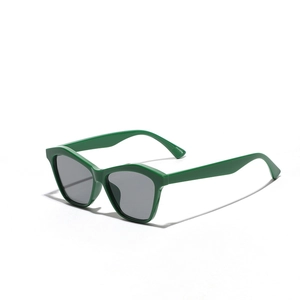 Modern cat-eye sunglasses with vibrant green frames and dark grey lenses on white background