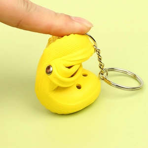 Mini yellow clog shoe keychain made of flexible silicone with a durable metal ring
