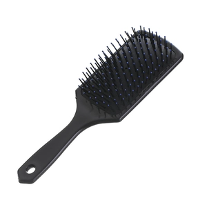 Professional anti-static black cushion hairbrush with blue massage tips and ergonomic handle