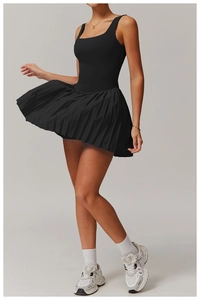 Detail of a black tennis dress featuring a square neck and pleated hem for active movement