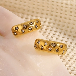 Detailed close-up of gold stainless steel rings with star and heart zircon engravings