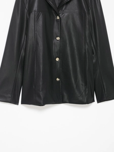 Close-up of black leather jacket featuring lapel collar and button closure detail