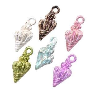 Detailed macro view of colorful enamel conch shell charms for DIY jewelry making
