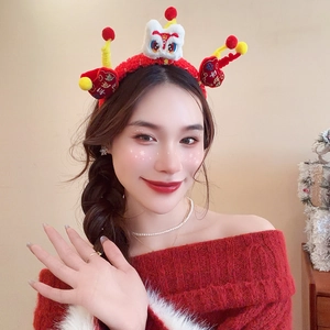 Detail of red plush festive headband featuring traditional Chinese lion dance decoration