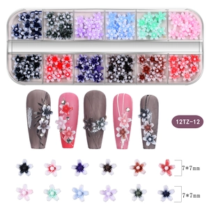 Macro view of 3D nail art flower charms in 12-grid storage box with 7x7mm size detail
