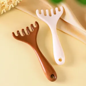 Antler-shaped head and neck massage comb set in amber and cream resin with five smooth claws