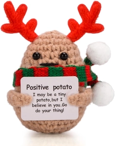 Macro detail of hand-knitted positive potato toy with reindeer antlers and scarf