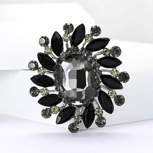 Detail view of radioactive flower brooch with grey crystals and black marquise gems