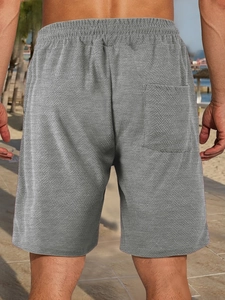 Detailed back view of men's grey casual shorts featuring unique jacquard texture fabric