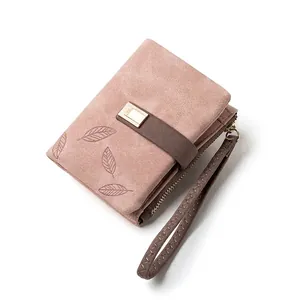 Dusty pink foldable wallet for women featuring leaf embossing and a wristlet strap