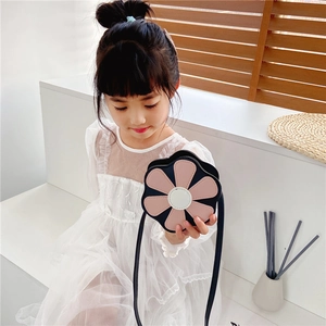 Close-up of pink flower crossbody bag for girls with leather texture and black strap