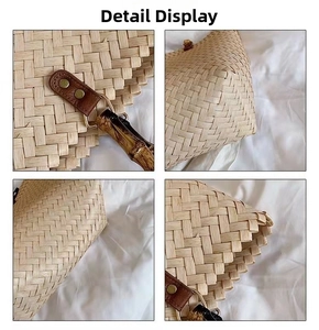 Detail of woven straw tote bag with bamboo handle and brown leather metal hardware