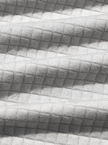 Close-up of gray waffle knit fabric texture on a casual business half-zip sweatshirt