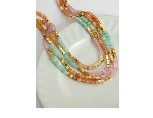 Detail of handmade beaded necklace with amazonite crystal beads and golden metal spacers