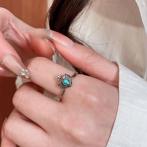 Macro shot of vintage crown ring with turquoise stone and heart-shaped silver design