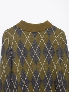 Detail of argyle knit polo shirt neck featuring olive green ribbing and soft texture