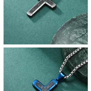 Detail view of T-shaped stainless steel pendant with carbon fiber inlay and blue finish