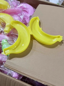 Detailed overhead view of multiple banana shaped plastic storage cases in a storage bin