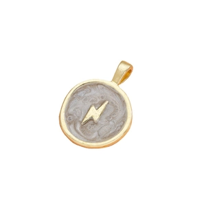 Golden round pendant with gray pearlescent inlay and lightning bolt symbol on white background