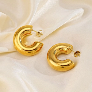 Chunky hollow C-shape 18K gold plated stainless steel hoop earrings on silk background