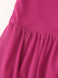 Detailed macro shot of pleated rose red mesh fabric texture on the elegant dress