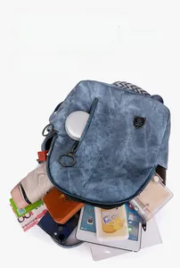 Detail view of blue soft leather backpack showing large interior space for A4 items