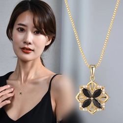 Detailed view of a gold clover necklace with black marquise stones and crystal accents