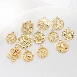 Detailed view of assorted gold-plated vintage charms featuring zirconia and retro patterns
