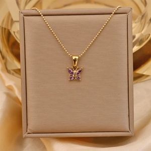 Detail of 18K gold plated titanium necklace with a purple zircon butterfly pendant